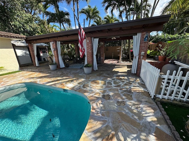 view of patio with a fenced in pool and a gazebo