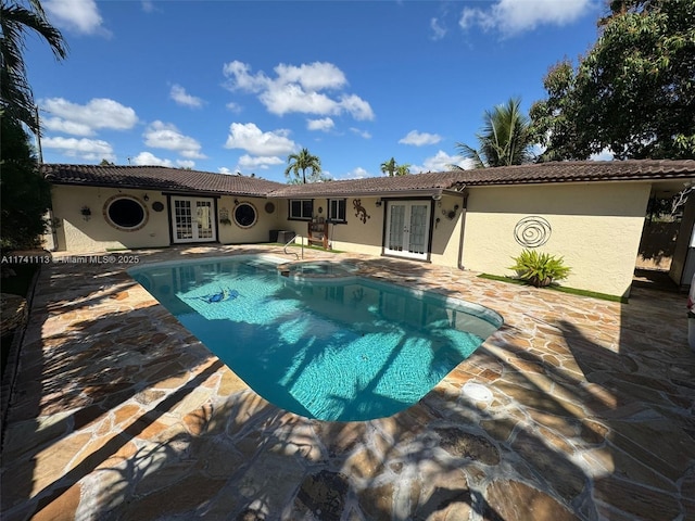 view of pool featuring a patio area and french doors