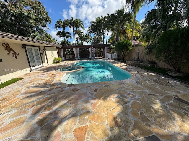 view of pool featuring an in ground hot tub, a patio area, and french doors