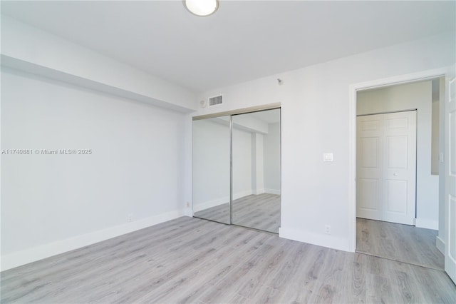 3530 Mystic Pointe Dr Unit 1513, Aventura, FL 33180 - unfurnished bedroom featuring a closet and light hardwood / wood-style flooring