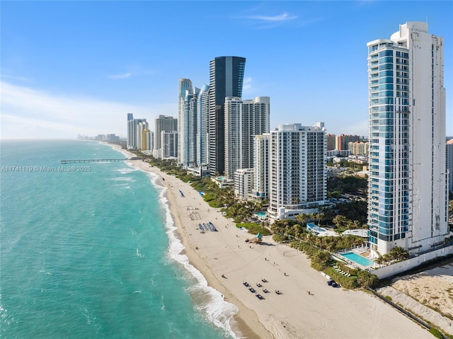 drone / aerial view featuring a beach view and a water view