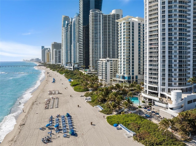 drone / aerial view featuring a view of the beach and a water view