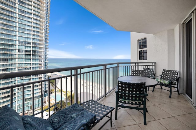 balcony featuring a water view and a view of the beach