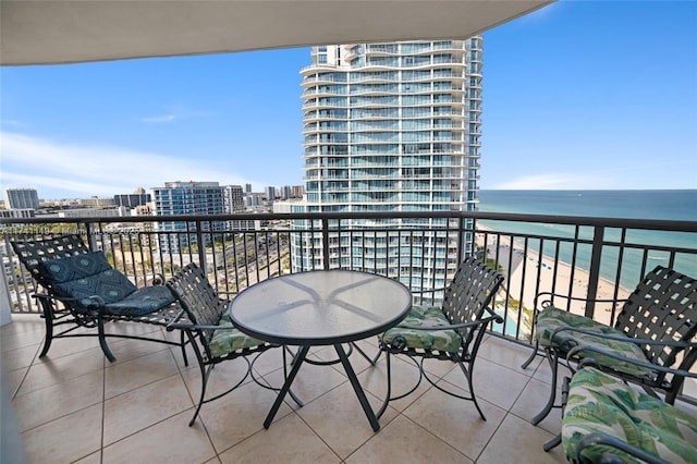 balcony featuring a water view and a view of the beach