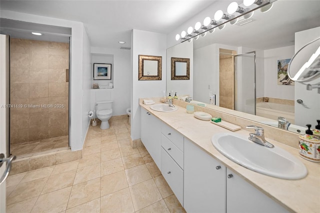 full bathroom featuring tile patterned flooring, vanity, separate shower and tub, and toilet