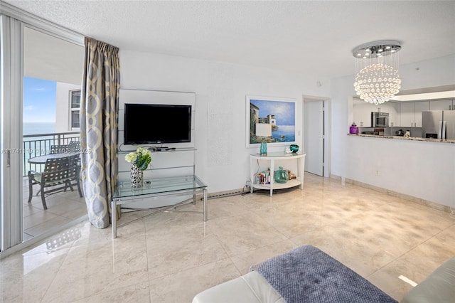 living room featuring a textured ceiling and a notable chandelier