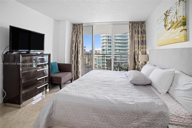 bedroom with floor to ceiling windows, a textured ceiling, and access to outside