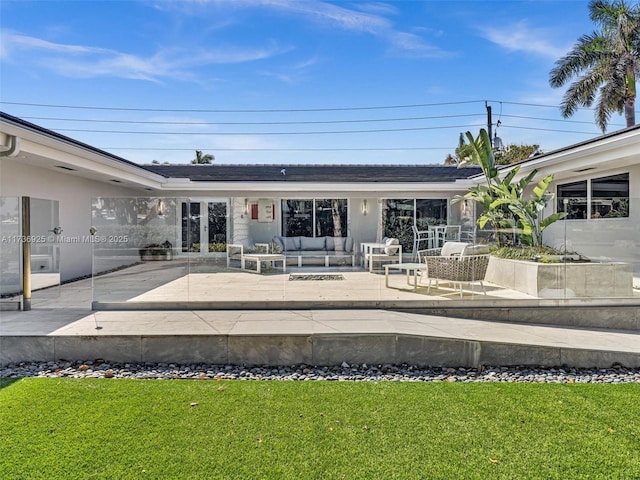 back of house with a yard, an outdoor hangout area, and a patio