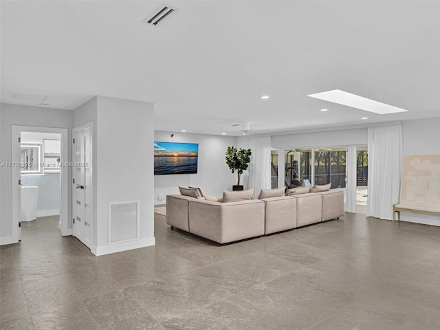 living room featuring a skylight