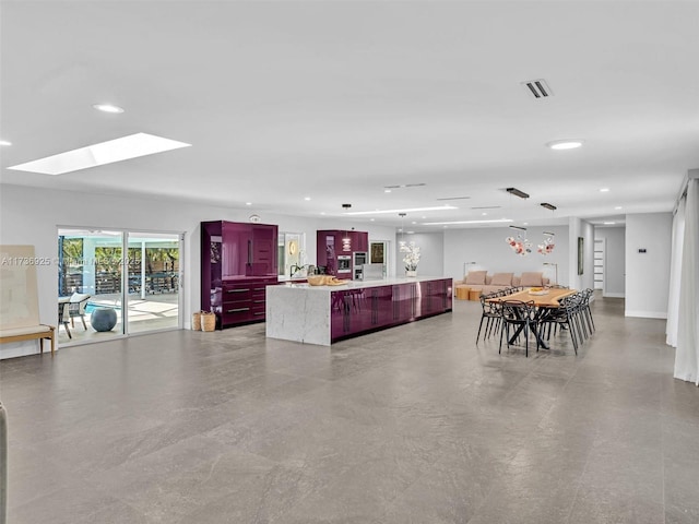 dining room with a skylight