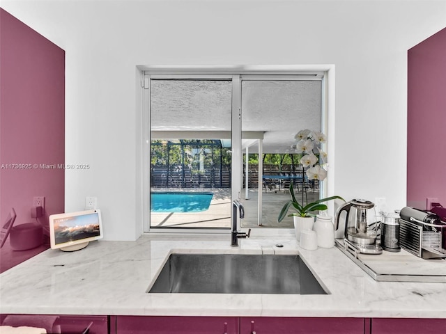 kitchen with sink and light stone counters