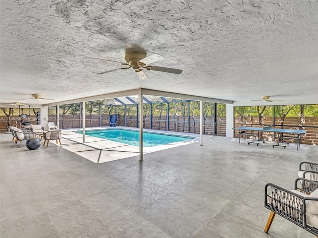 view of swimming pool featuring ceiling fan, outdoor lounge area, and a patio