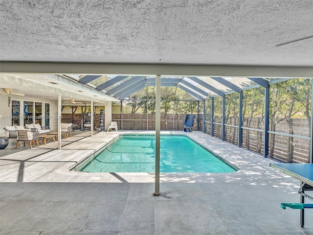 view of pool featuring a patio area and glass enclosure