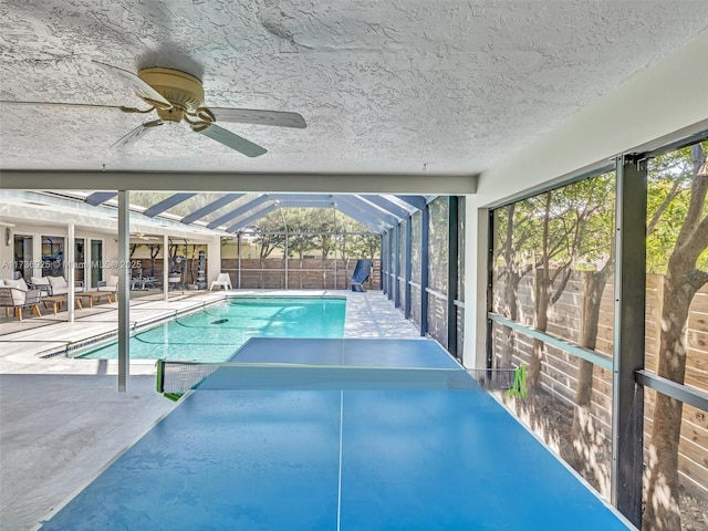 view of pool featuring a lanai, a patio, and ceiling fan