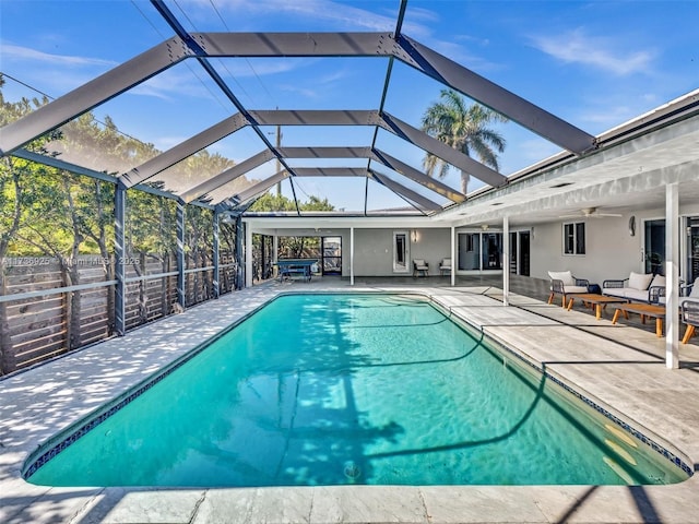 view of pool featuring a lanai, outdoor lounge area, a patio, and ceiling fan