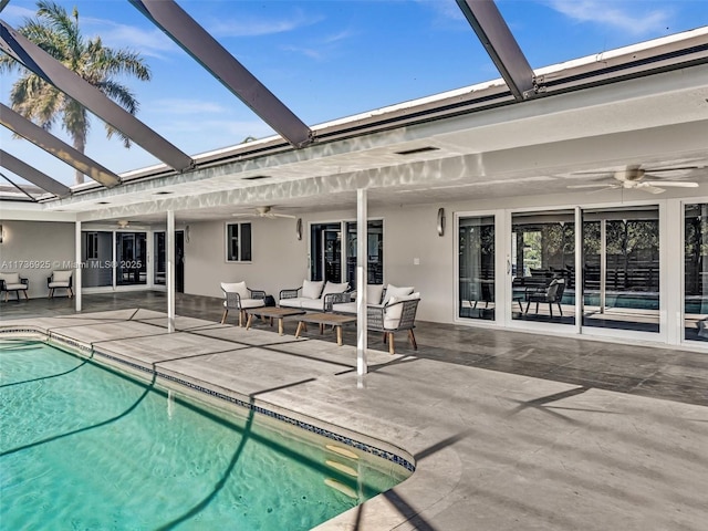 view of swimming pool featuring ceiling fan, outdoor lounge area, and a patio