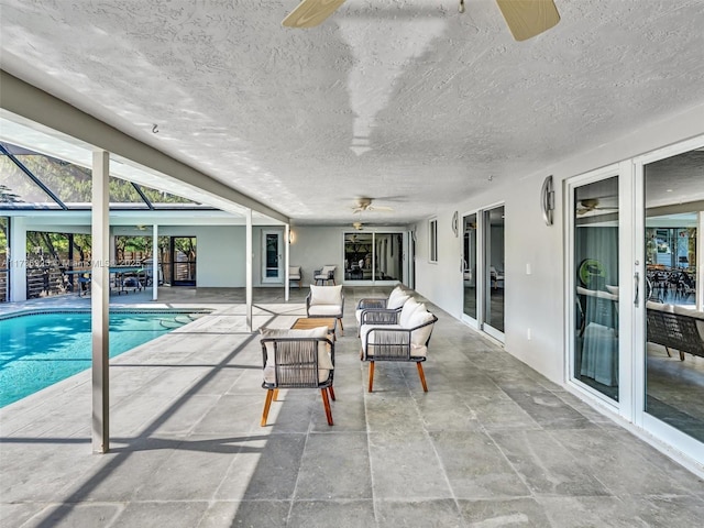 view of pool with ceiling fan, a lanai, and a patio area