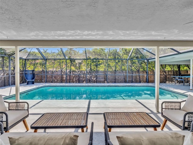 view of pool featuring a patio and glass enclosure