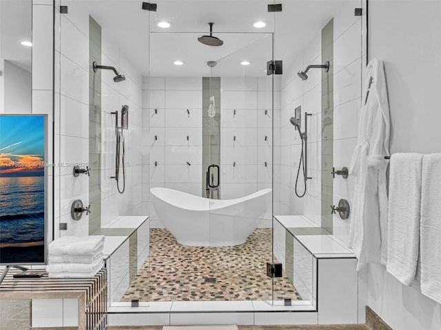 bathroom with separate shower and tub and tile walls