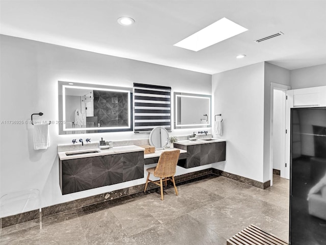 bathroom with vanity and a skylight