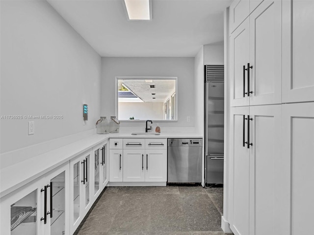 kitchen featuring white cabinetry, sink, and appliances with stainless steel finishes