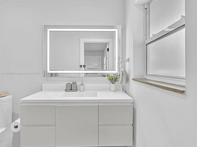 bathroom with vanity and toilet