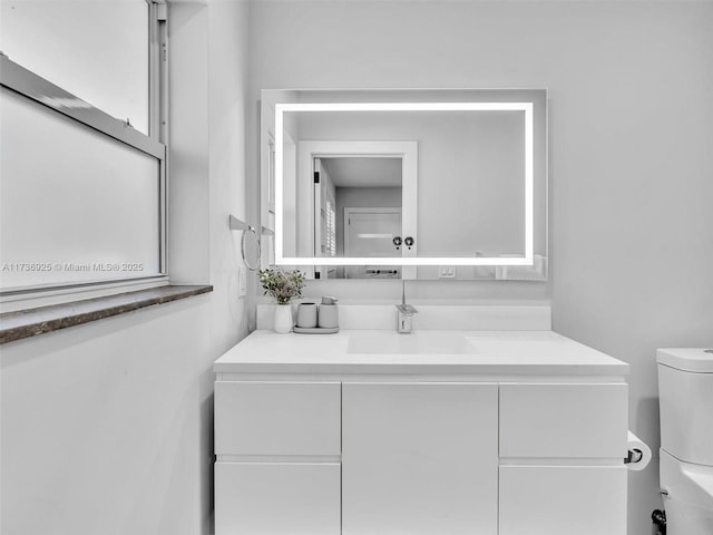 bathroom featuring vanity and toilet