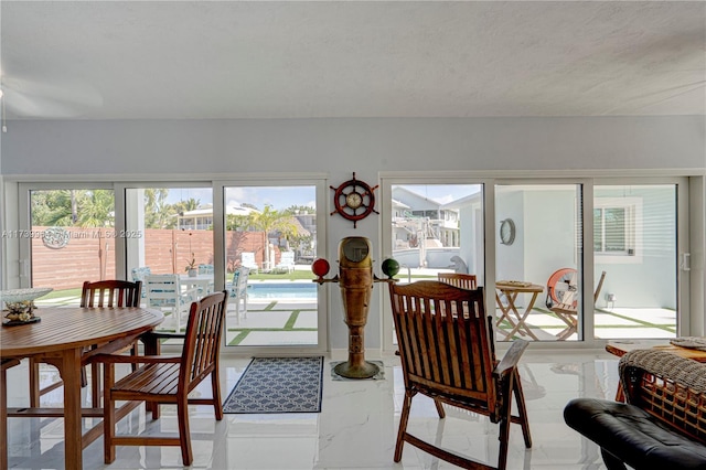 dining space featuring marble finish floor