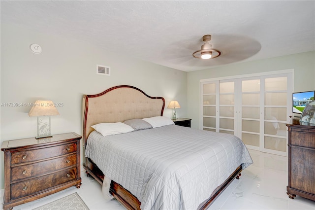 bedroom featuring marble finish floor, visible vents, and ceiling fan