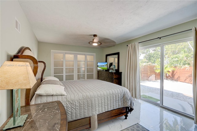 bedroom with visible vents, a ceiling fan, marble finish floor, access to outside, and a textured ceiling