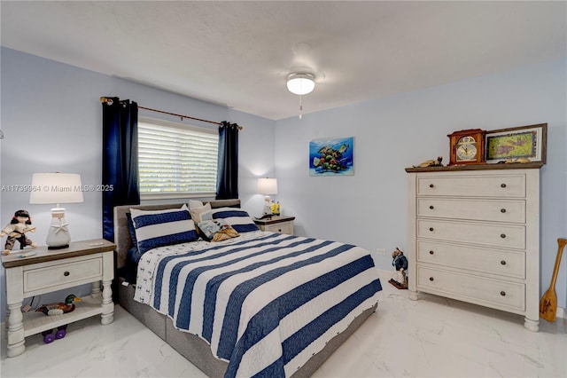 bedroom featuring marble finish floor and a ceiling fan