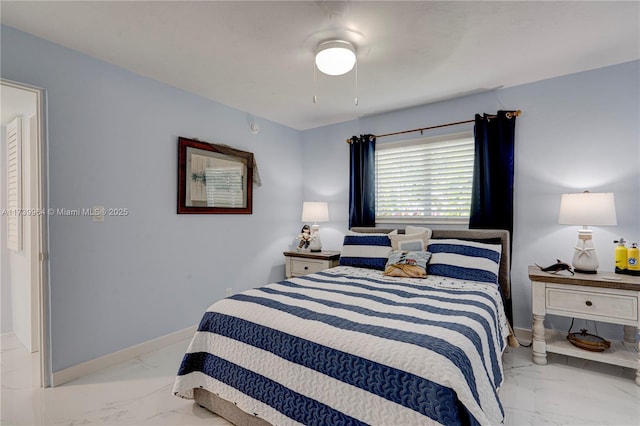 bedroom with marble finish floor, a ceiling fan, and baseboards