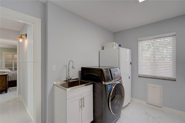 laundry area with cabinet space, washer / dryer, baseboards, marble finish floor, and a sink