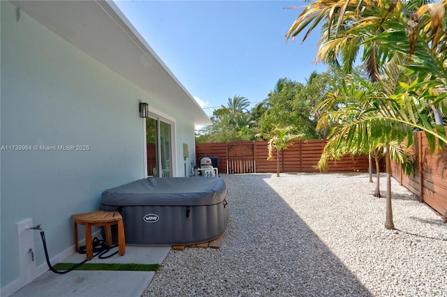 view of patio / terrace featuring a fenced backyard and a hot tub