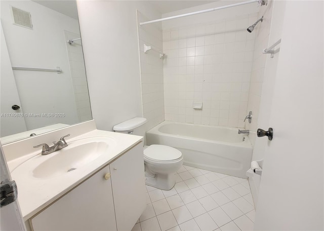 full bathroom featuring vanity, tiled shower / bath, tile patterned floors, and toilet