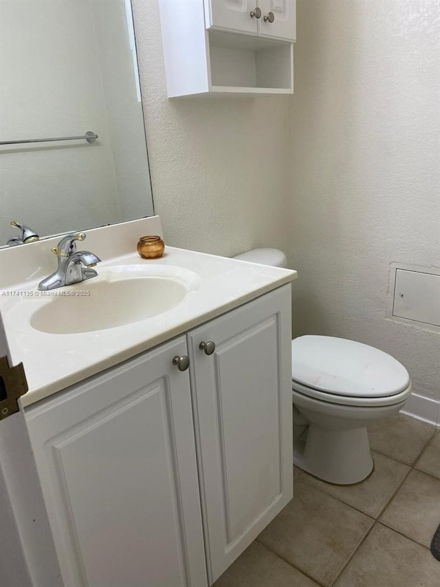 bathroom featuring vanity, toilet, and tile patterned flooring