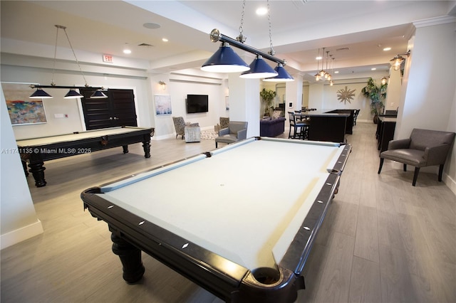 playroom with pool table, a tray ceiling, and light hardwood / wood-style flooring