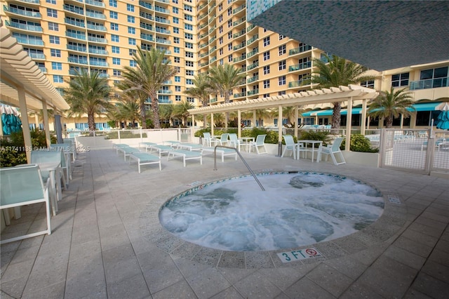 view of pool featuring a community hot tub, a pergola, and a patio