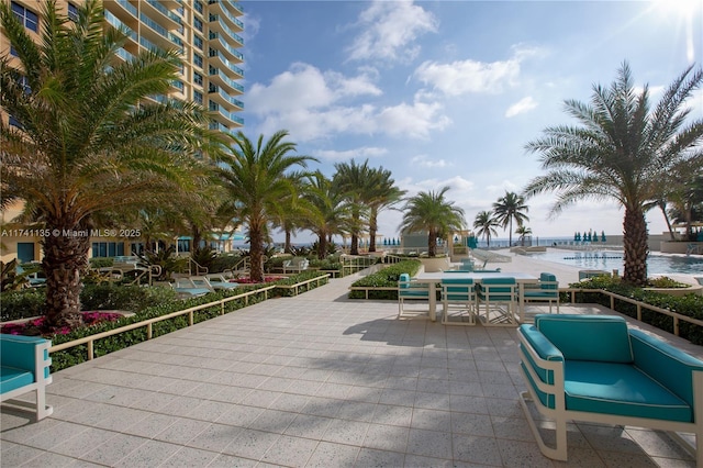 view of community with a water view and a patio