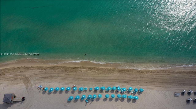 aerial view featuring a water view and a view of the beach