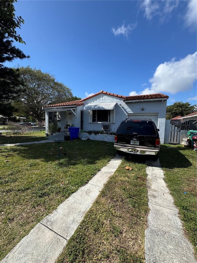 view of front facade with a garage and a front lawn