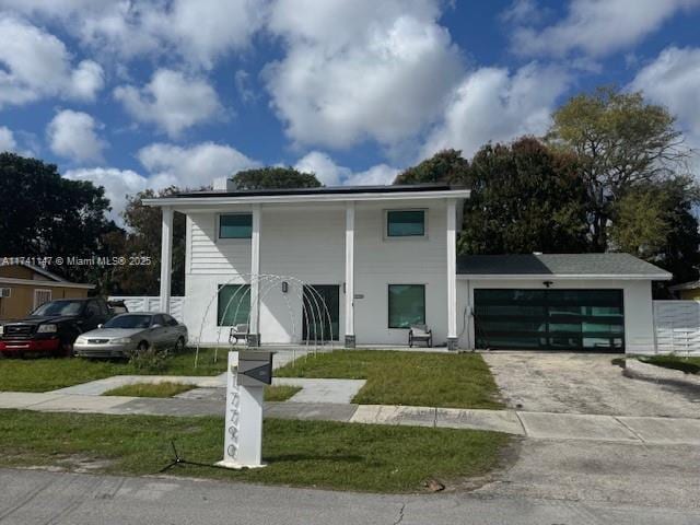 view of front facade with a garage and a front lawn