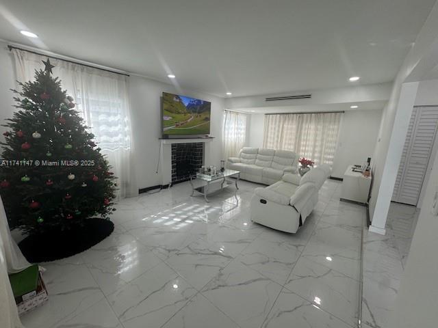 living room with a wealth of natural light and a fireplace