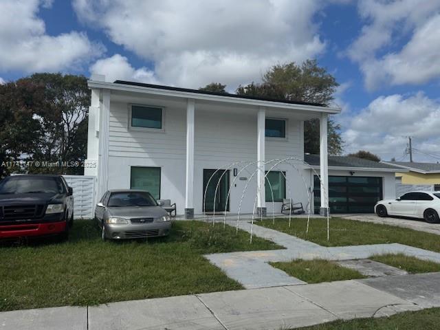 view of front of home featuring a garage and a front yard