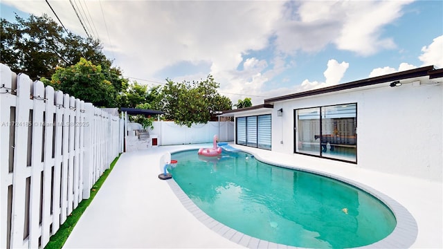 view of swimming pool with a patio