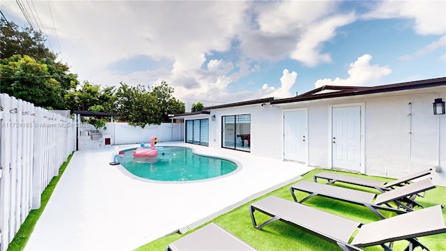 view of pool featuring a patio