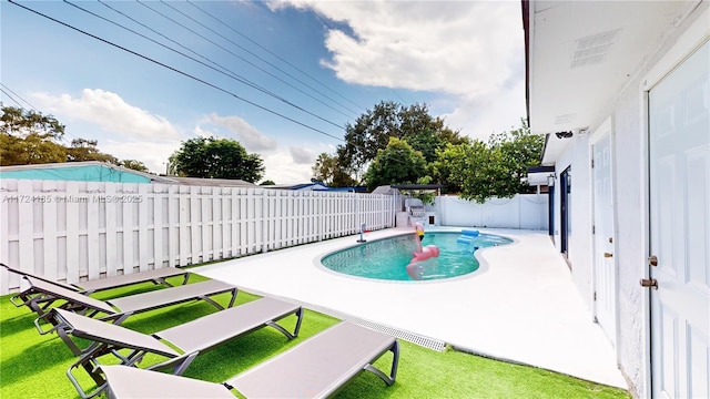 view of swimming pool with a patio and a lawn