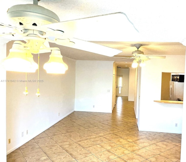 tiled spare room with ceiling fan