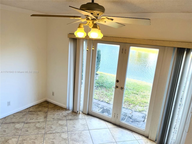 doorway to outside featuring french doors, a wealth of natural light, a textured ceiling, and light tile patterned floors