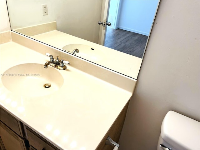 bathroom with vanity, wood-type flooring, and toilet